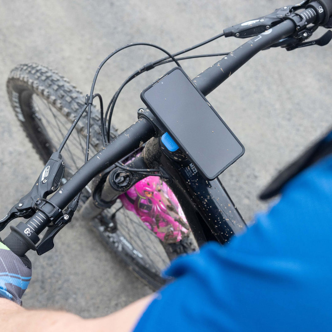 Quad Lock Out Front Mount Pro - Lifestyle of Phone Held Up by Mount on Bicycle Handlebar
