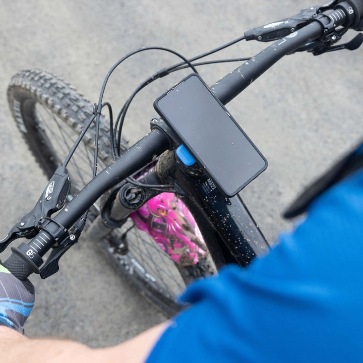 Quad Lock Out Front Mount Pro - Lifestyle of Phone Held Up by Mount on Bicycle Handlebar