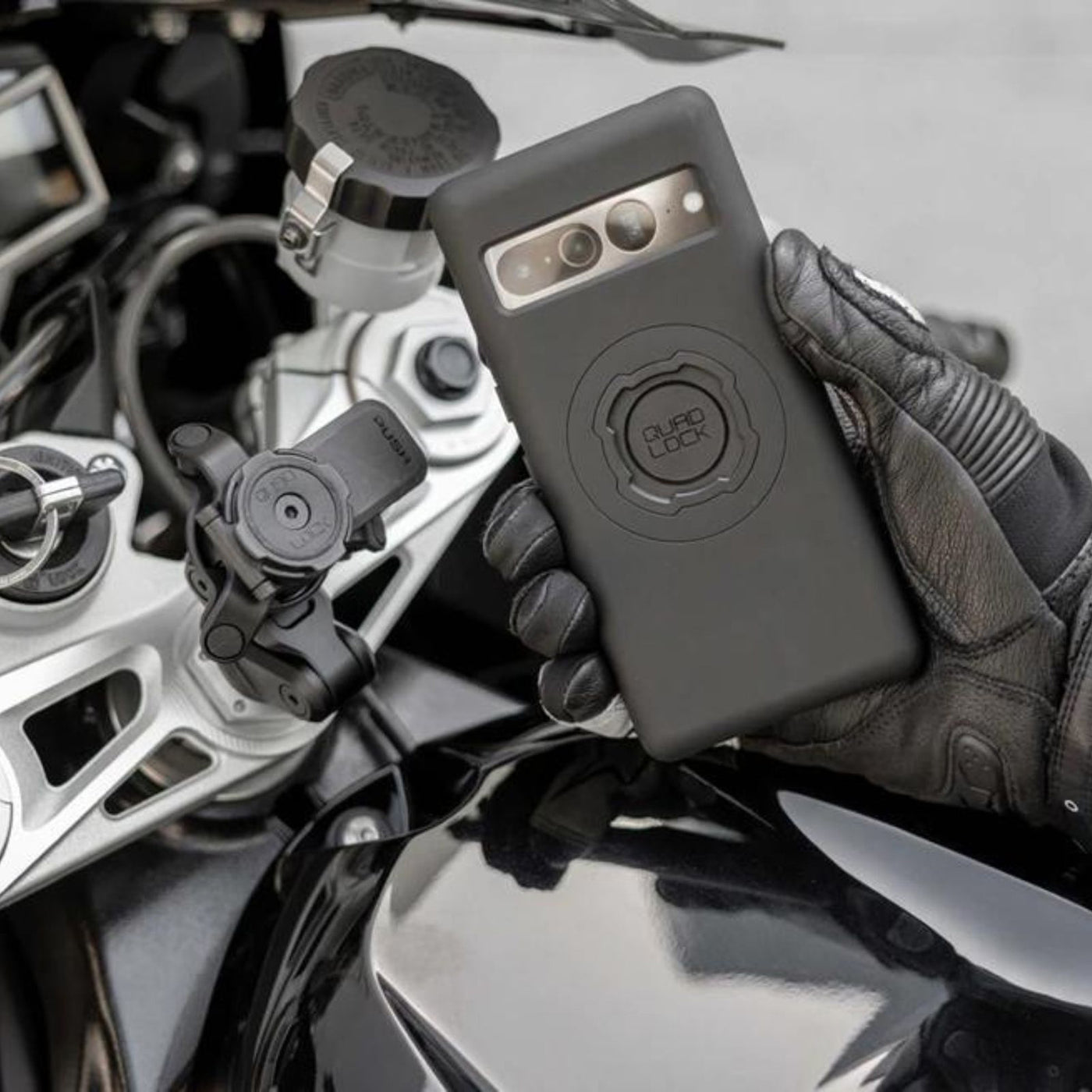 Quad Lock Phone Case - Google Pixel 7 Series - Lifestyle of Rider Lining Up Phone Case with Mount Head Lever