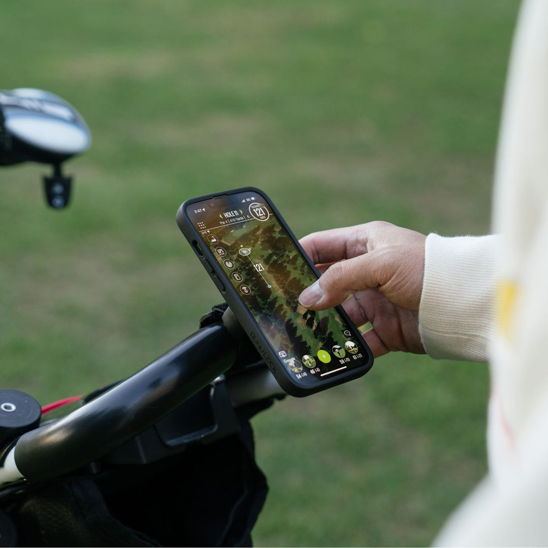 Quad Lock Quick Release Strap Mount - Lifestyle of User Checking Map on Phone on Mount Strapped to Handle