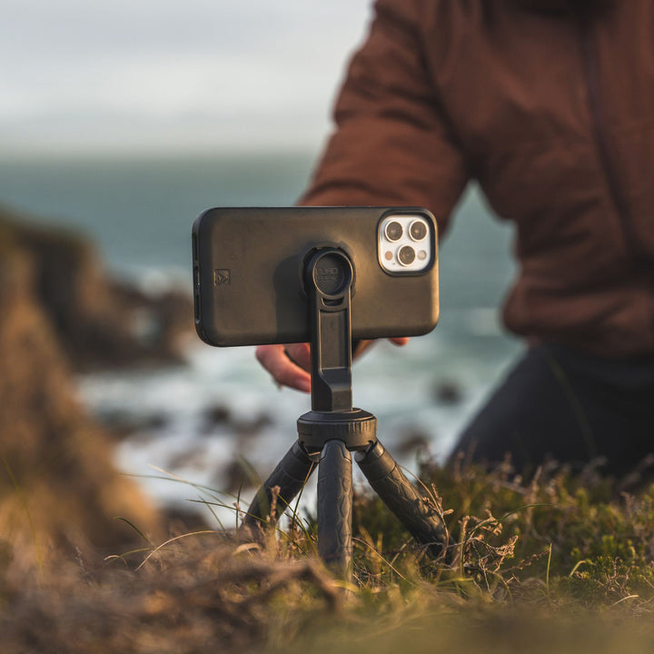 Quad Lock Tripod Adaptor (V3) - Lifestyle of Model Setting up Phone on Tripod