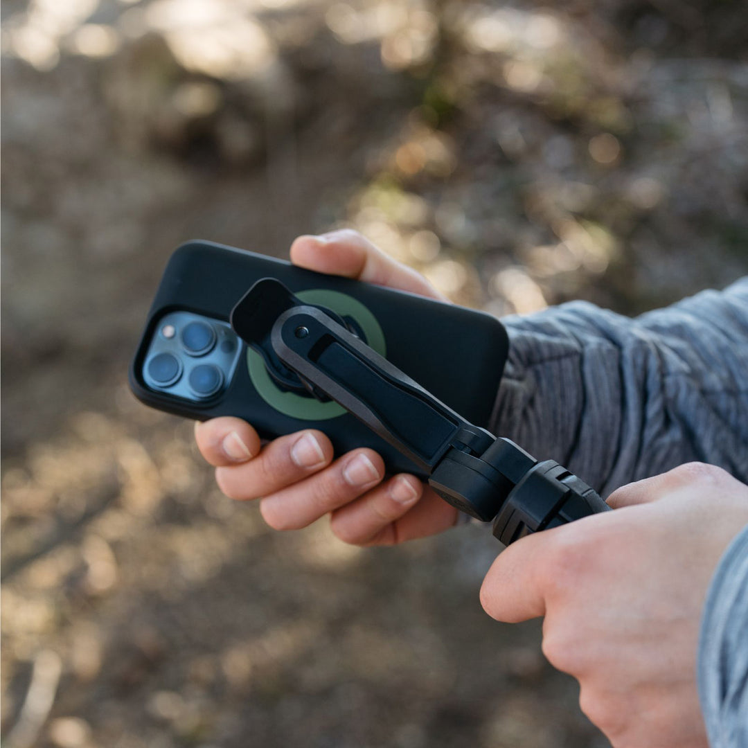Quad Lock Tripod/Selfie Stick - Lifestyle Close-up of Model Attaching Phone Case to Selfie Stick