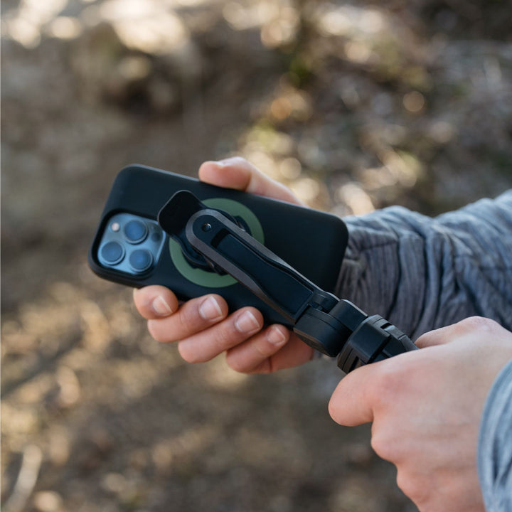 Quad Lock Tripod/Selfie Stick - Lifestyle Close-up of Model Attaching Phone Case to Selfie Stick