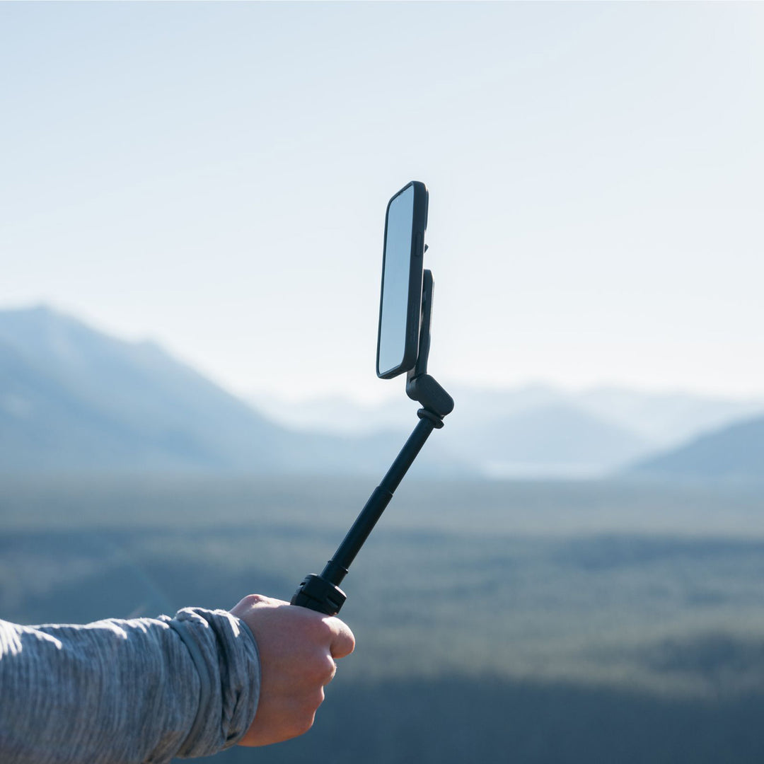 Quad Lock Tripod/Selfie Stick - Lifestyle of Model Holding Phone Out on Selfie Stick