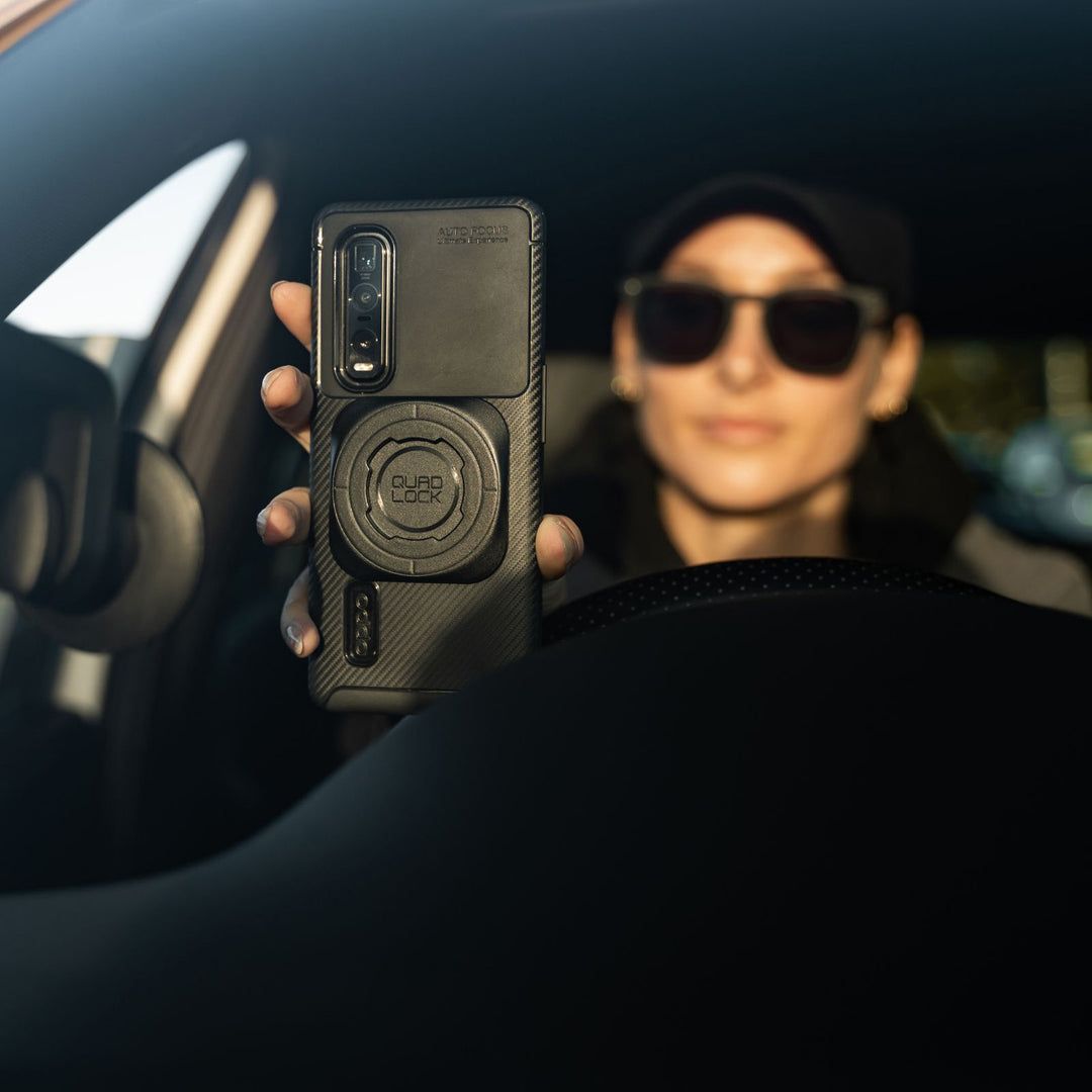 Quad Lock Universal Adaptor MAG - Lifestyle of Car Driver About to Lock Phone to Windshield Mount