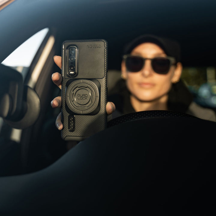 Quad Lock Universal Adaptor MAG - Lifestyle of Car Driver About to Lock Phone to Windshield Mount