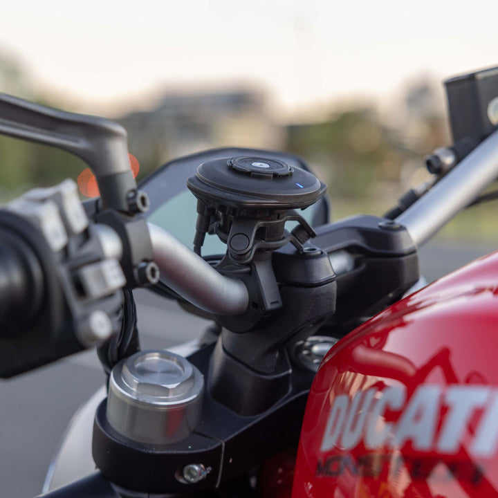 Quad Lock USB Weatherproof Wireless Charging Head - Lifestyle Close-Up of Charging Head on Motorcycle Handlebar Mount