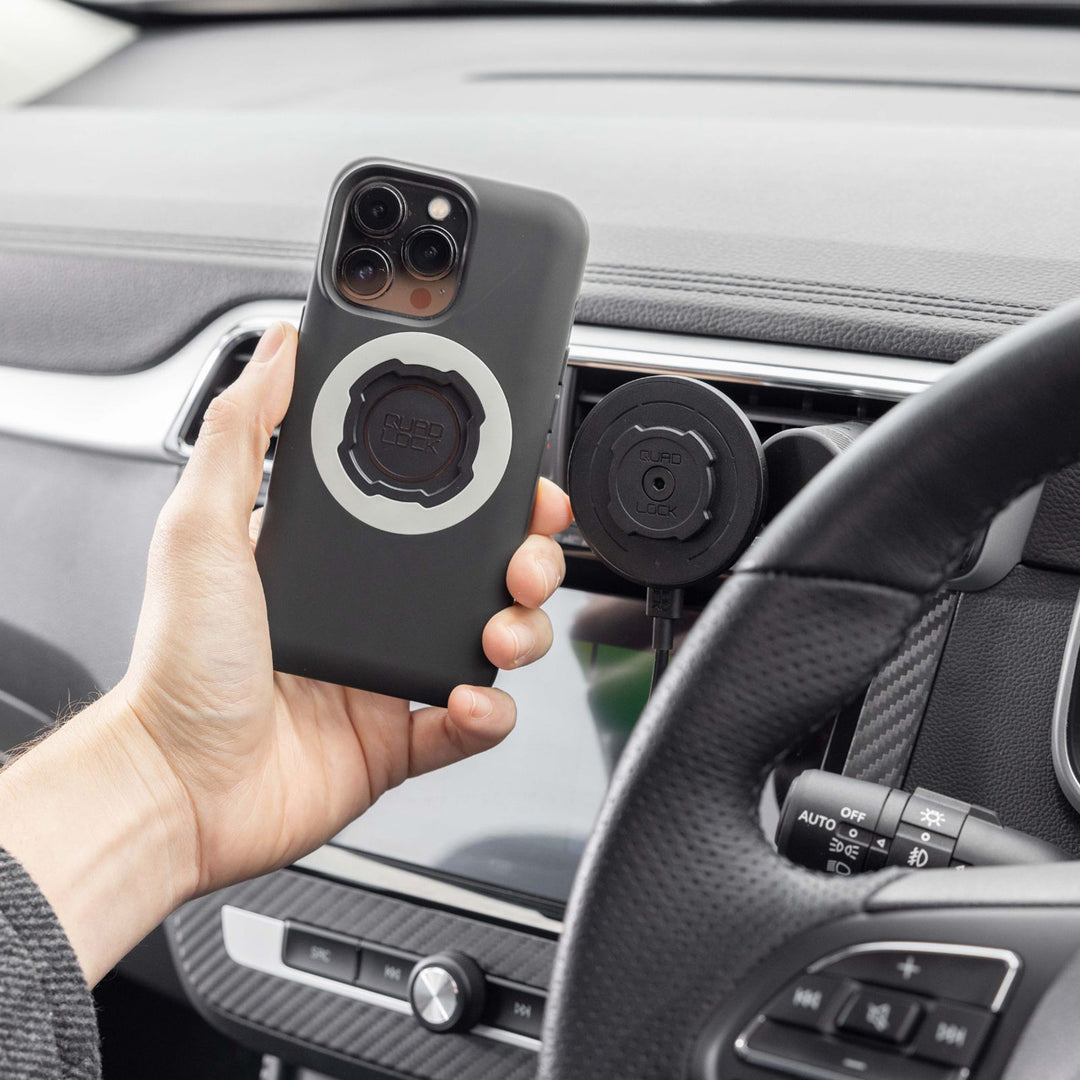 Quad Lock Vent Car Mount - Lifestyle of Driver Lining Phone Case Up with Vent Mount Head