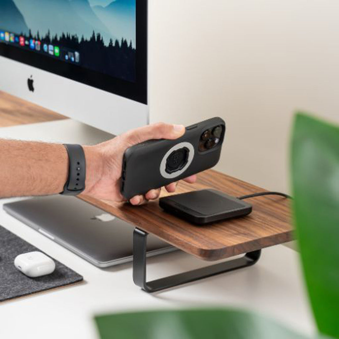 Quad Lock Wireless Charging Pad - Lifestyle of Model Setting Phone on Charging Pad