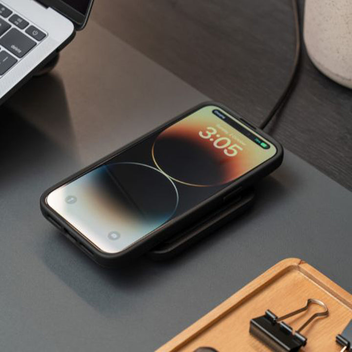 Quad Lock Wireless Charging Pad - Lifestyle of Phone on Charging Pad next to Laptop