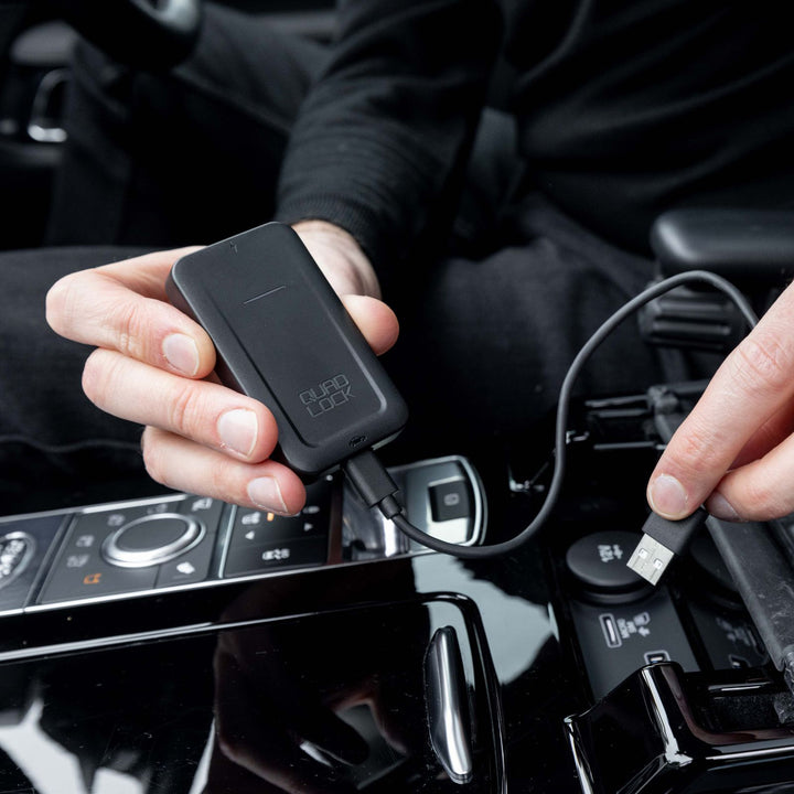 Quad Lock Wireless CarPlay Adaptor - Lifestyle of Driver Plugging Adaptor into Center Console