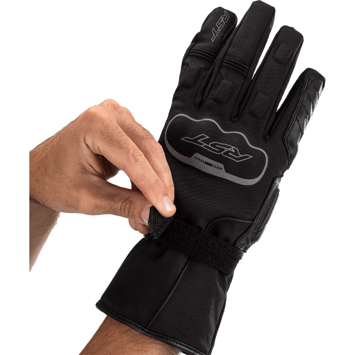 RST Axiom CE Waterproof Gloves Black - Close-Up of Model Adjusting Wrist Strap