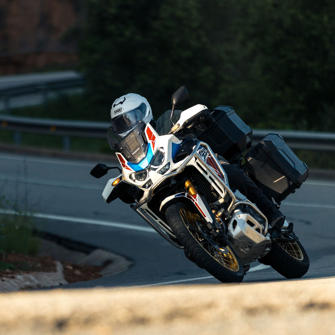 Shoei GT-Air 3 Solid Helmet White - Lifestyle of Rider Wearing Helmet Coming Through Turn on Adventure Motorcycle