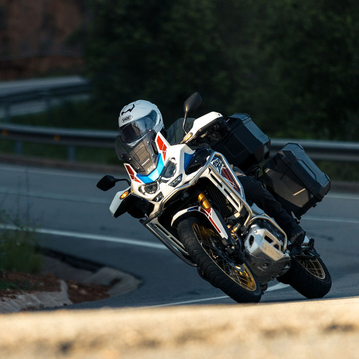 Shoei GT-Air 3 Solid Helmet White - Lifestyle of Rider Wearing Helmet Coming Through Turn on Adventure Motorcycle