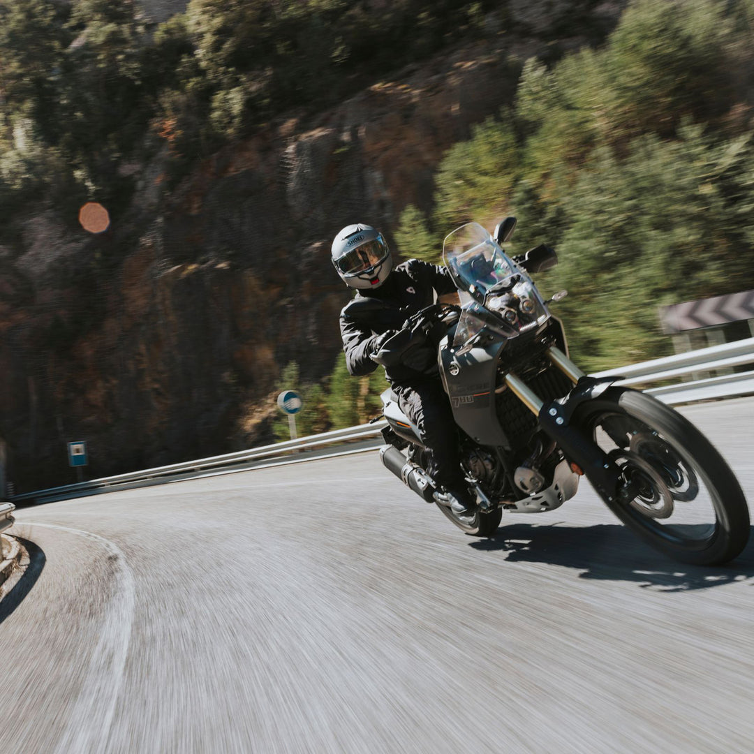 Shoei Neotec 3 Solid Helmet Anthracite Metallic - Lifestyle Shot of Rider wearing helmet on gray dual sport motorcycle
