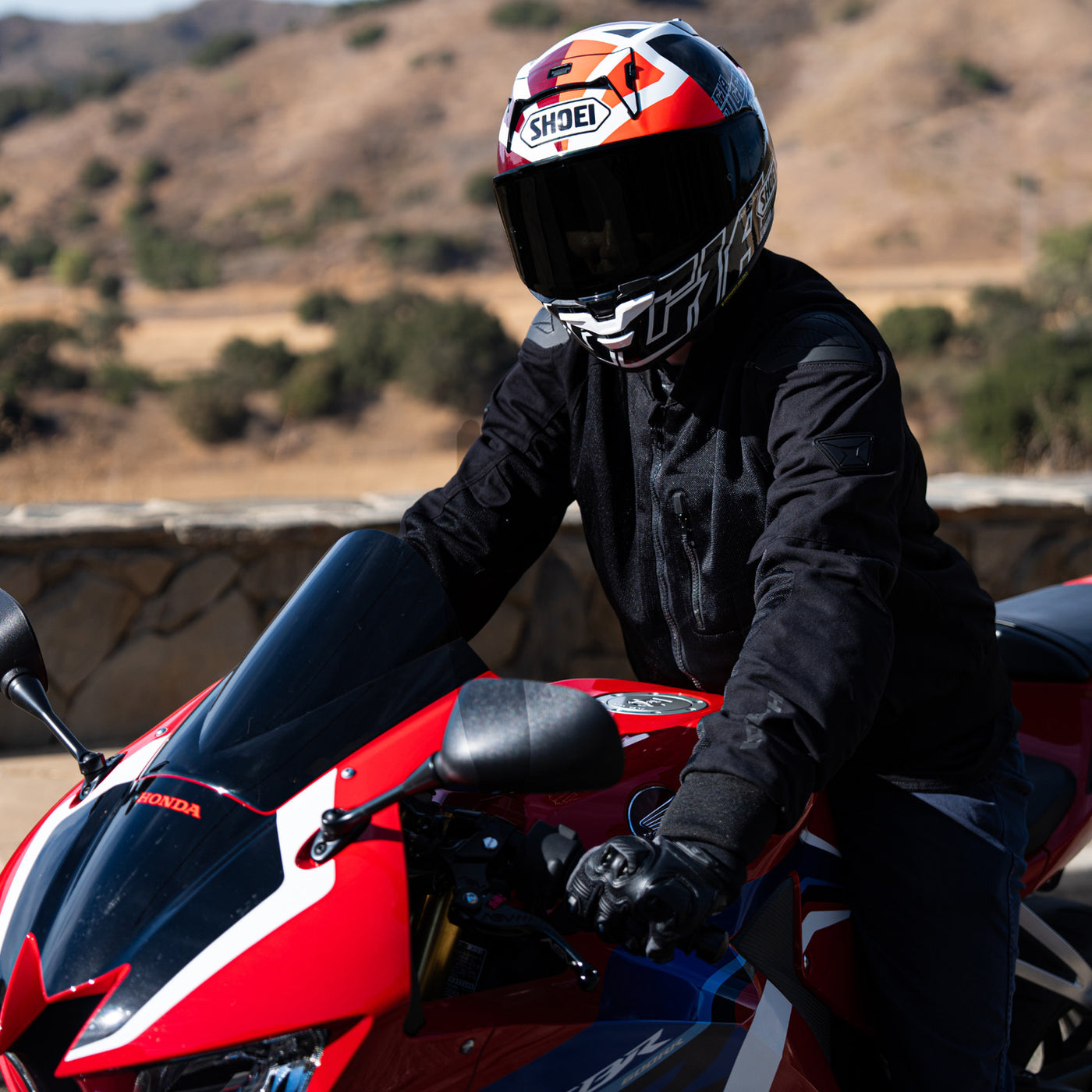 Shoei X-15 Diggia 2 Helmet TC-1 - lifestyle shot of rider wearing helmet on red motorcycle