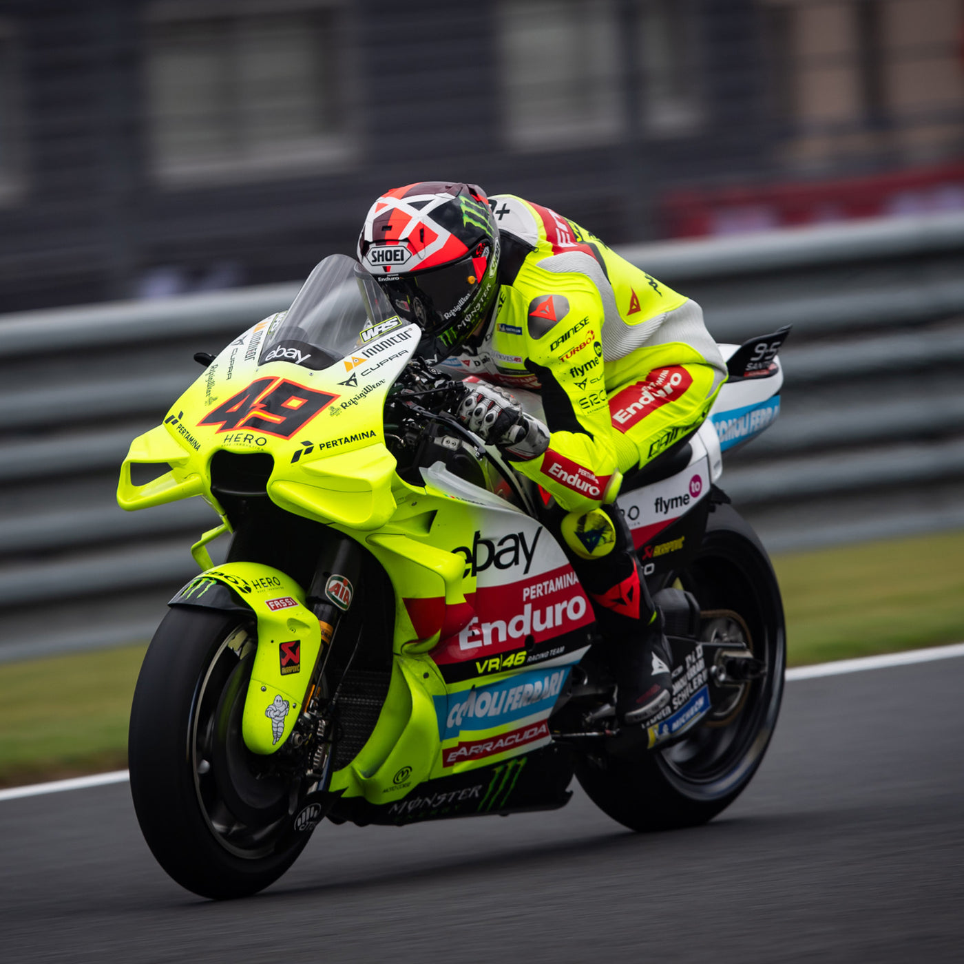 Shoei X-15 Diggia 2 Helmet TC-1 - lifestyle shot of racer wearing helmet on neon yellow motorcycle