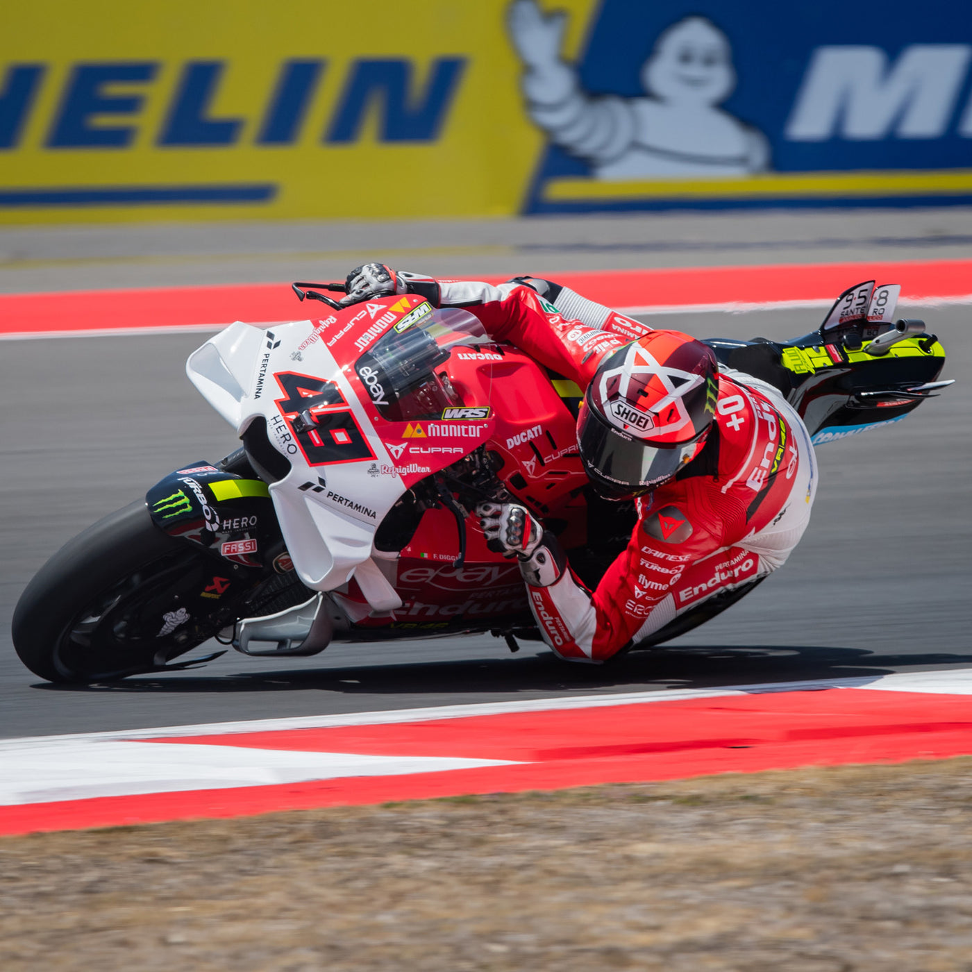 Shoei X-15 Diggia 2 Helmet TC-1 - lifestyle shot of racer wearing helmet on red and white motorcycle