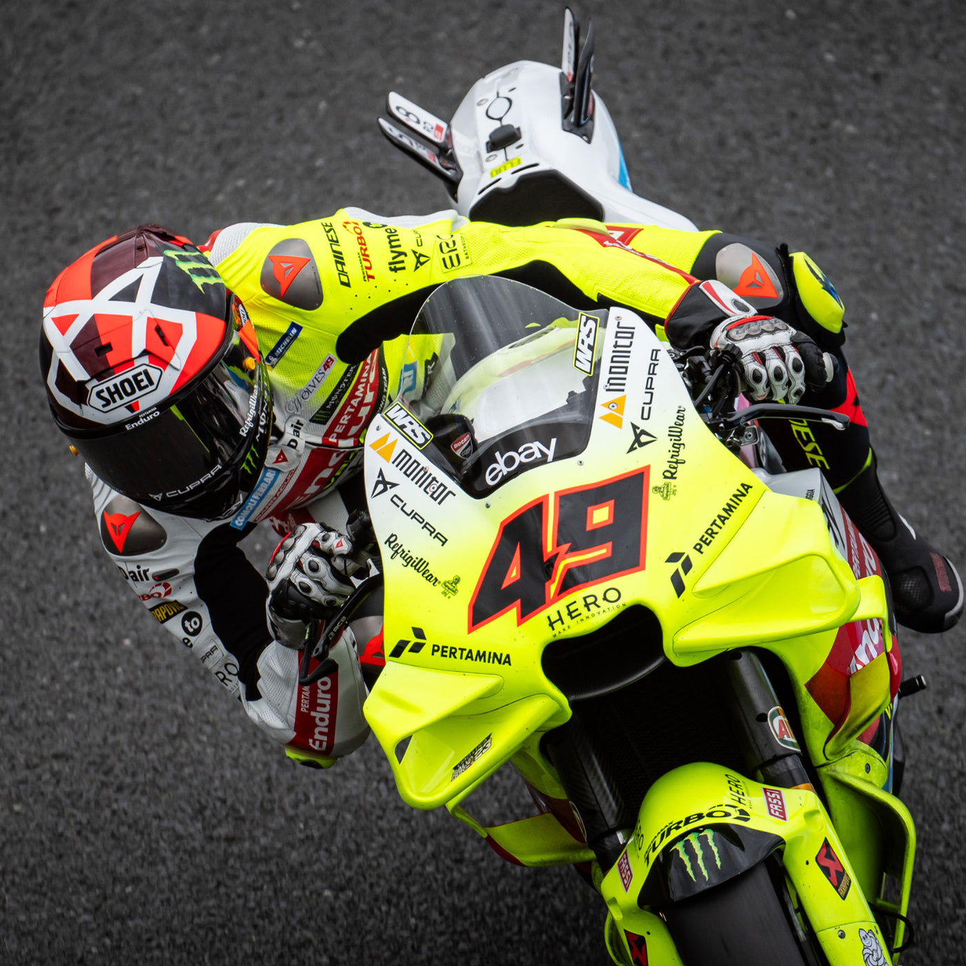 Shoei X-15 Diggia 2 Helmet TC-1 - lifestyle shot of racer wearing helmet on neon yellow motorcycle