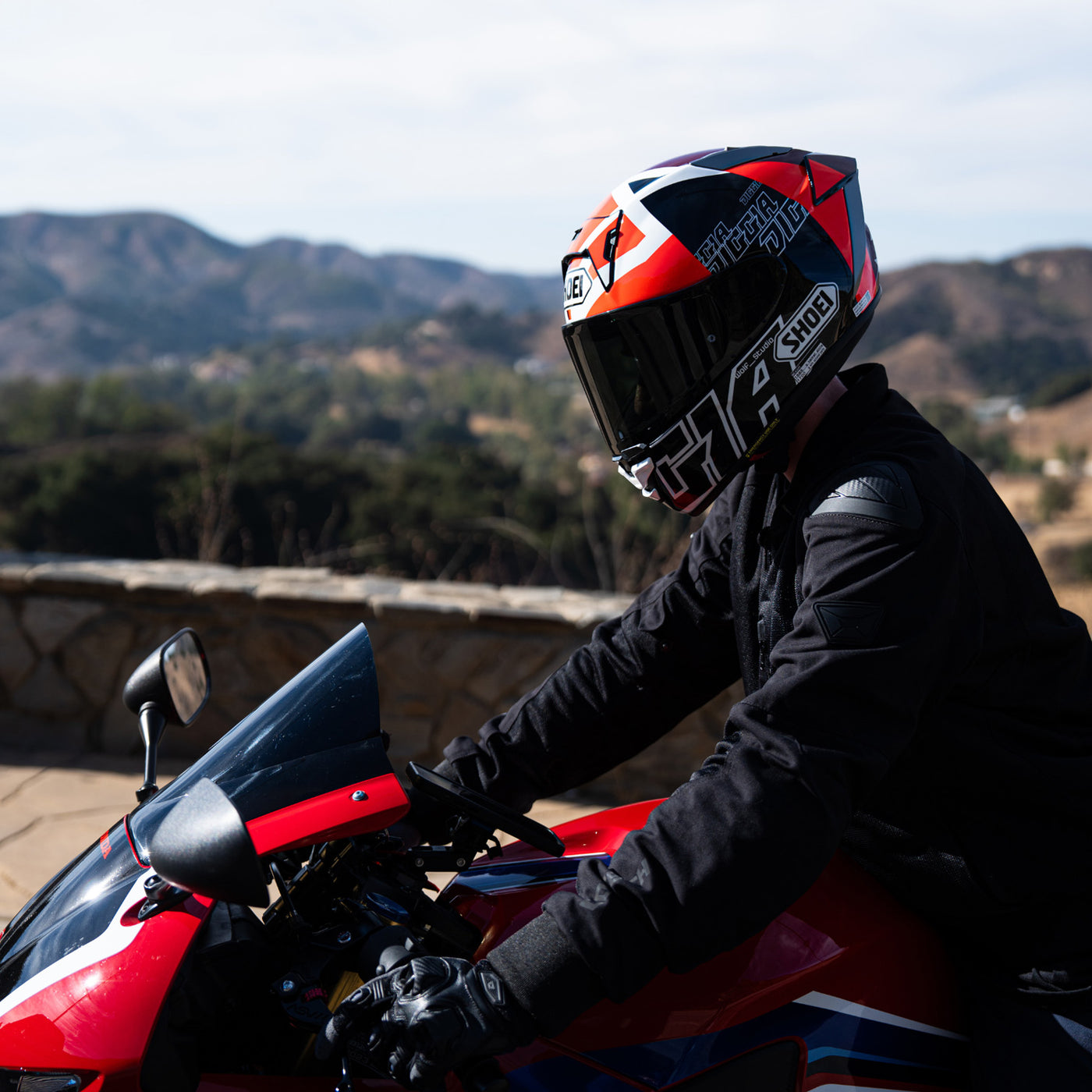 Shoei X-15 Diggia 2 Helmet TC-1 - lifestyle shot of rider wearing helmet on red motorcycle