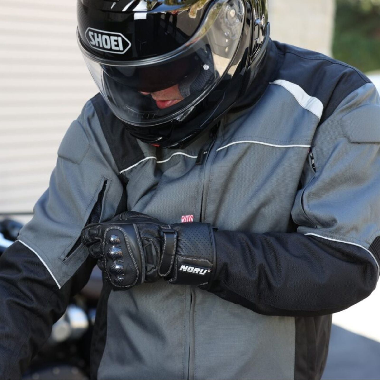 rider adjusting arm vent on Noru Taifu Waterproof Jacket in Gray