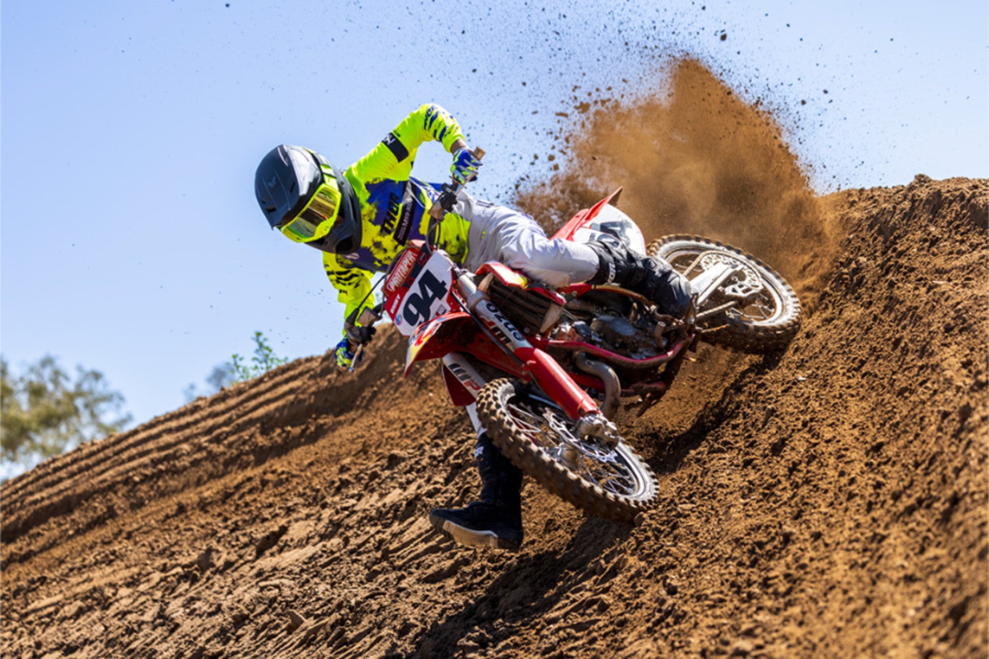 Action shot of dirt bike rider sliding out of turn