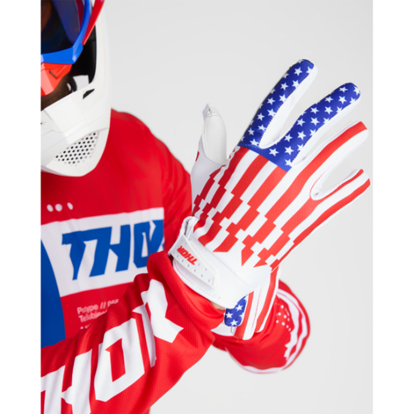 THOR LAUNCHMODE Patriot Gloves - Back of Hand View of Model Putting on Glove