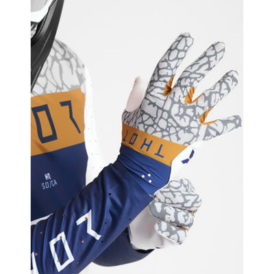 THOR SPORTMODE Bravo Gloves Navy/Copper - Back of Hand View of Model Putting on Glove