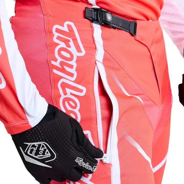 Troy Lee Designs GP Pro Spun Pants Red - Close-Up of Model Opening Zippered Pocket