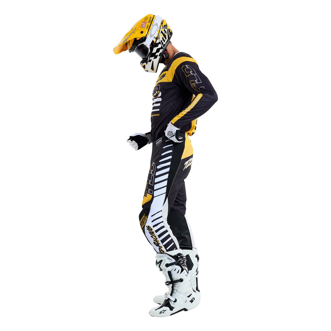 Troy Lee Designs GP Pro Fifty-50 Pants Black/Gold - Full Side View of Model Wearing Pants