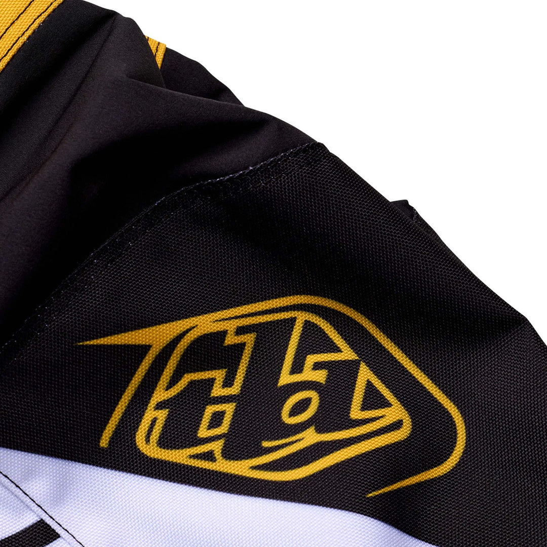 Troy Lee Designs GP Pro Fifty-50 Pants Black/Gold - Close-Up of TLD Logo Graphic on Knee