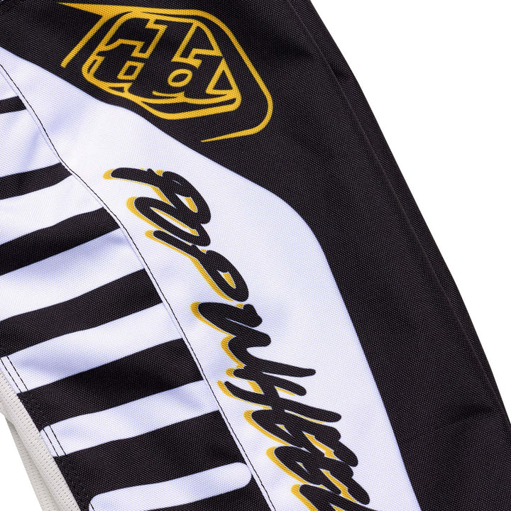 Troy Lee Designs GP Pro Fifty-50 Pants Black/Gold - Close-Up of Pop Wheelies Graphic on Calf