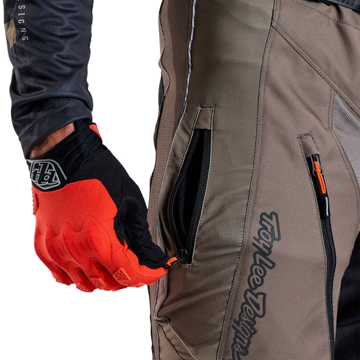 Troy Lee Designs Scout GP Solid Pants Tarmac - Close-Up of Model Opening Thigh Zippered Pocket