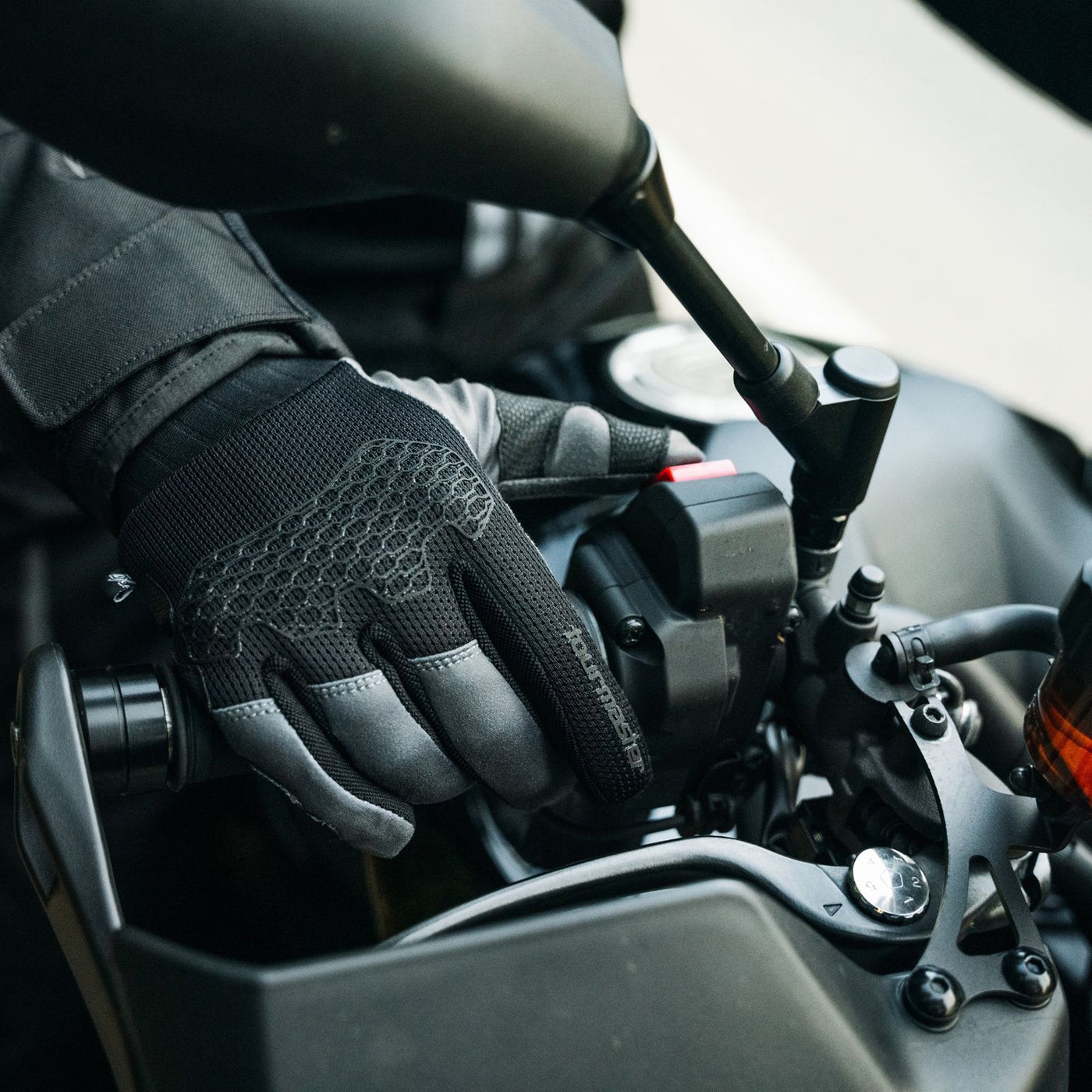 Tourmaster ADV Lite Air Gloves Black/Grey/Grey - Lifestyle Close-Up of Gloved Hand on Throttle Side Grip