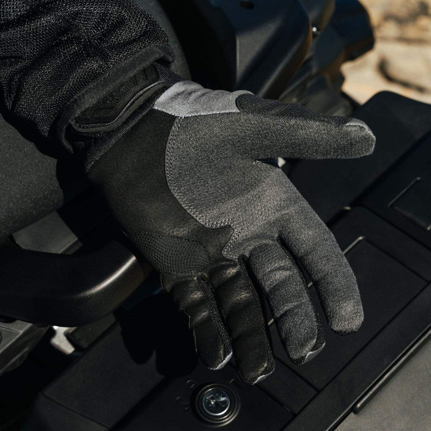 Tourmaster ADV Lite Air Gloves Black/Grey/Grey - Lifestyle Close-Up of Open Gloved Hand, Palm Up, over Saddlebags