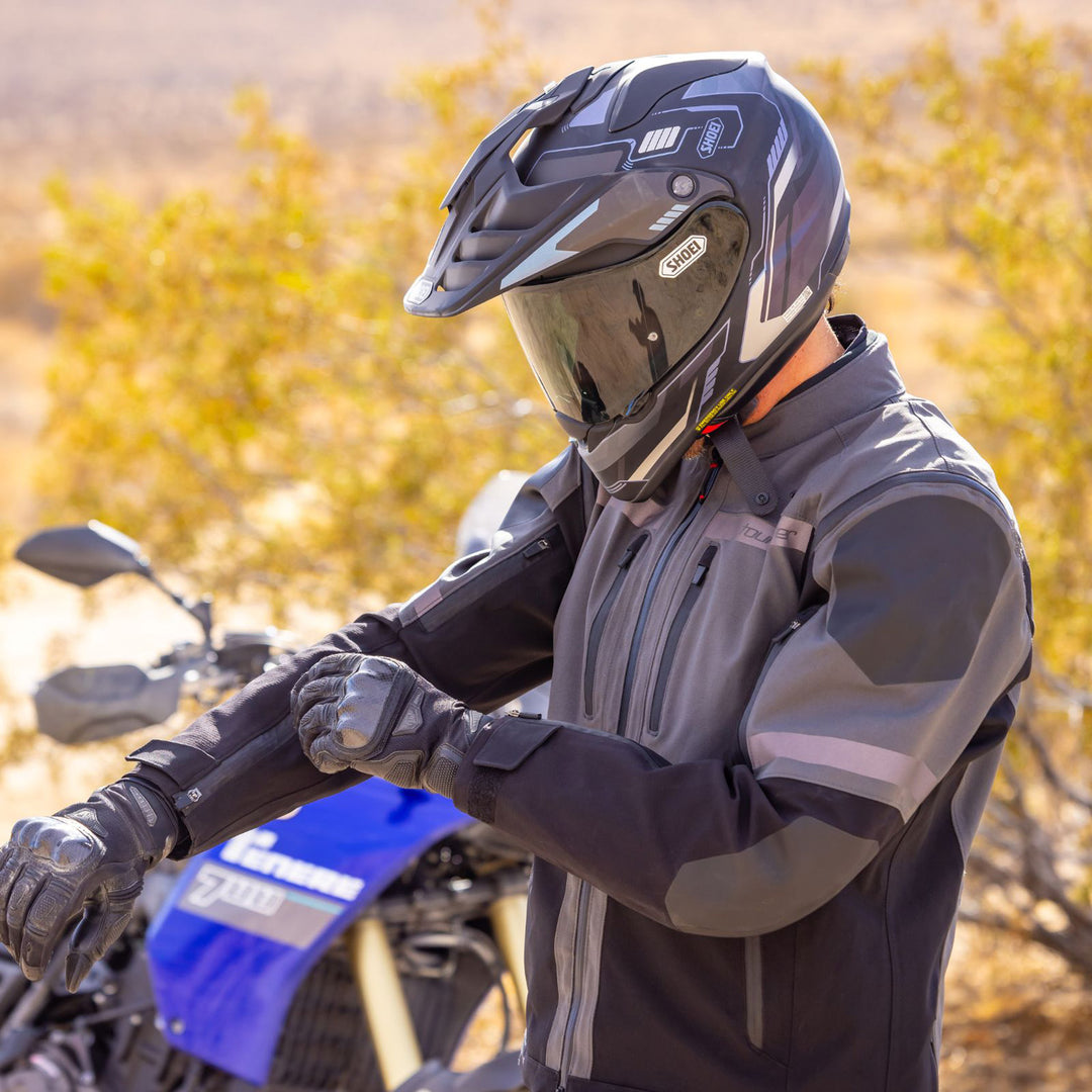 Tourmaster Adventure Lite Jacket Grey/Black - Lifestyle of Rider Wearing Jacket while Adjusting Wrist Fitment