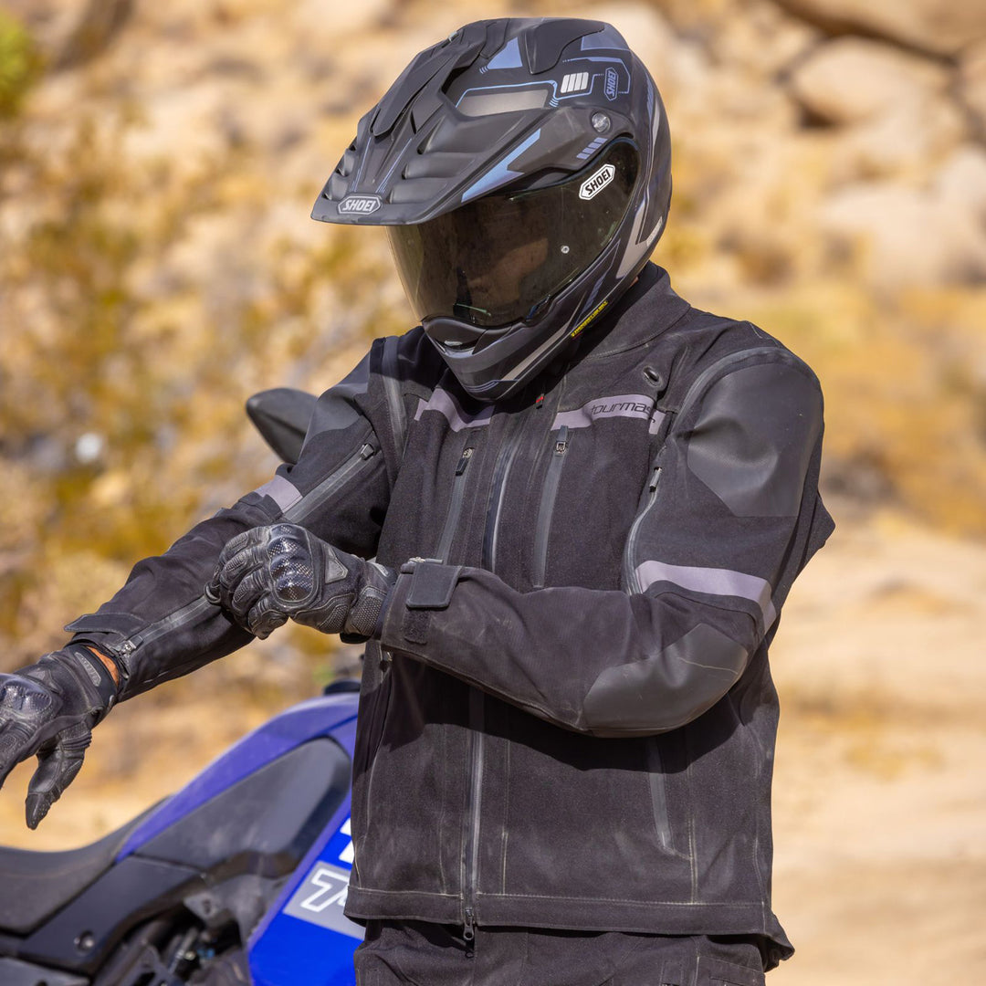 Tourmaster Adventure Lite Jacket Black - Lifestyle of Rider Wearing Jacket while Adjusting Wrist Fitment