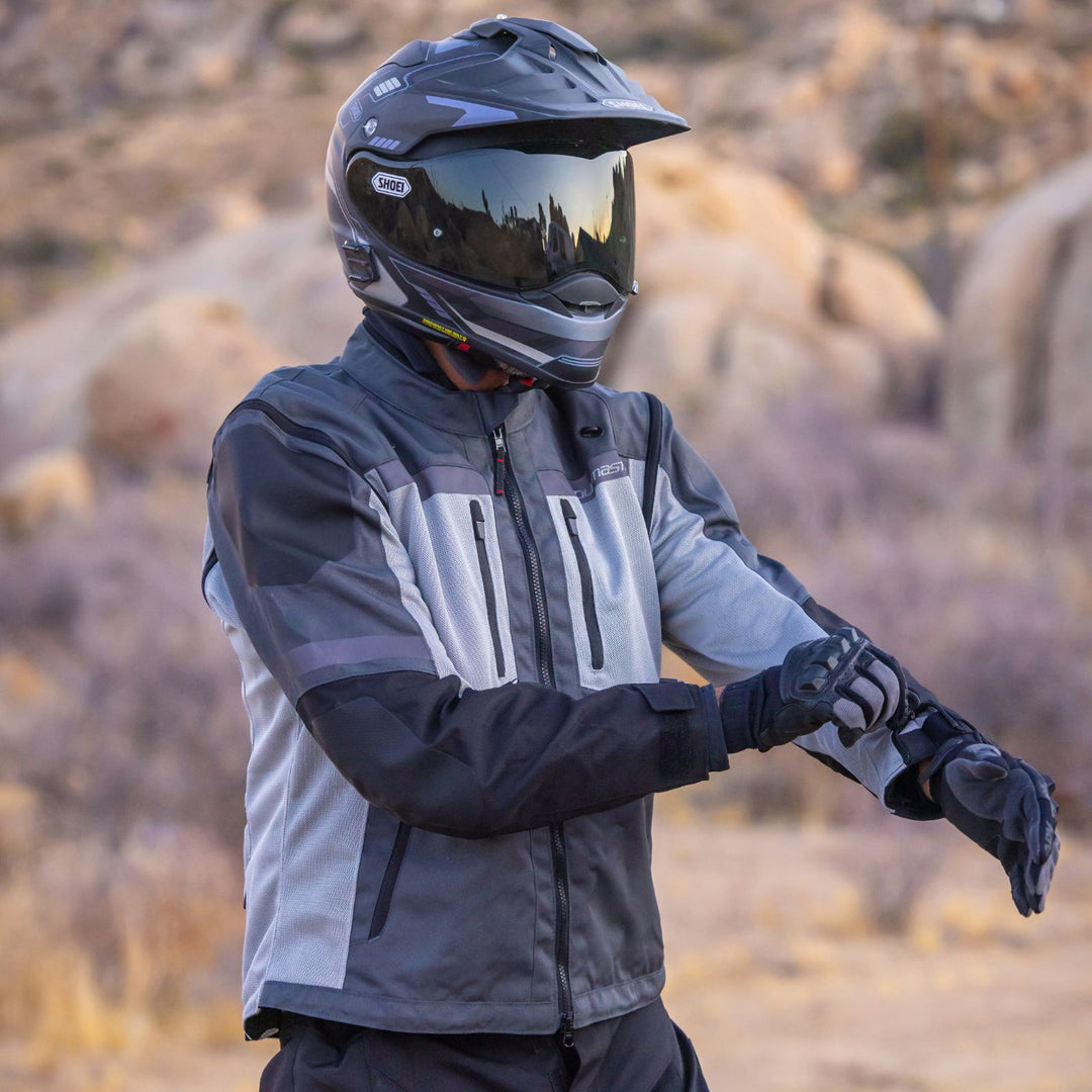 Tourmaster Adventure Lite Mesh Jacket Grey/Grey - Lifestyle of Rider Wearing Jacket and Adjusting Wrist Zipper