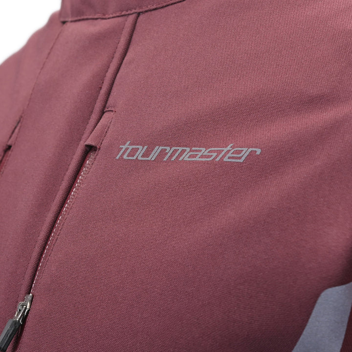 Tourmaster Women's Discovery Jacket Raisin/Canyon Sunset - Close-Up of Brand Logo on Chest
