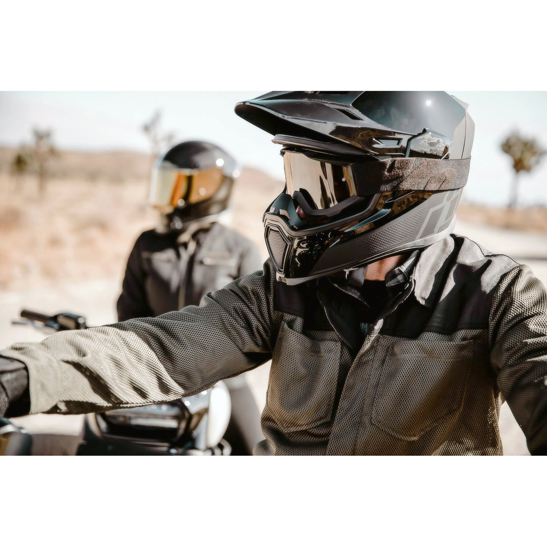 ICON Airflite™ Helmet Peak Black - Lifestyle Shot of Rider in Desert Wearing Helmet with Peak Installed