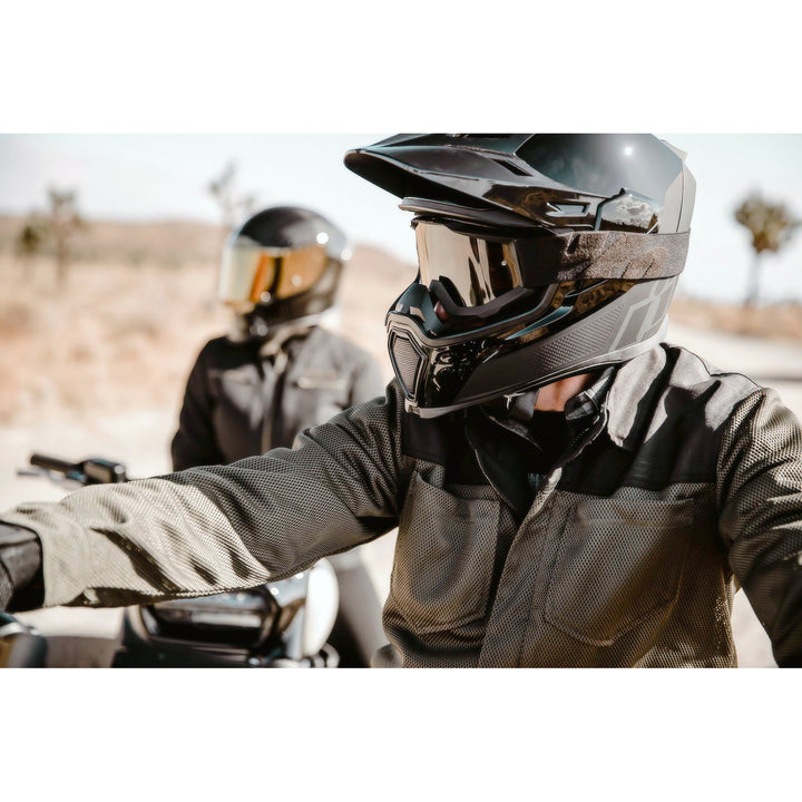 ICON Airflite™ Helmet Peak Black - Lifestyle Shot of Rider in Desert Wearing Helmet with Peak Installed