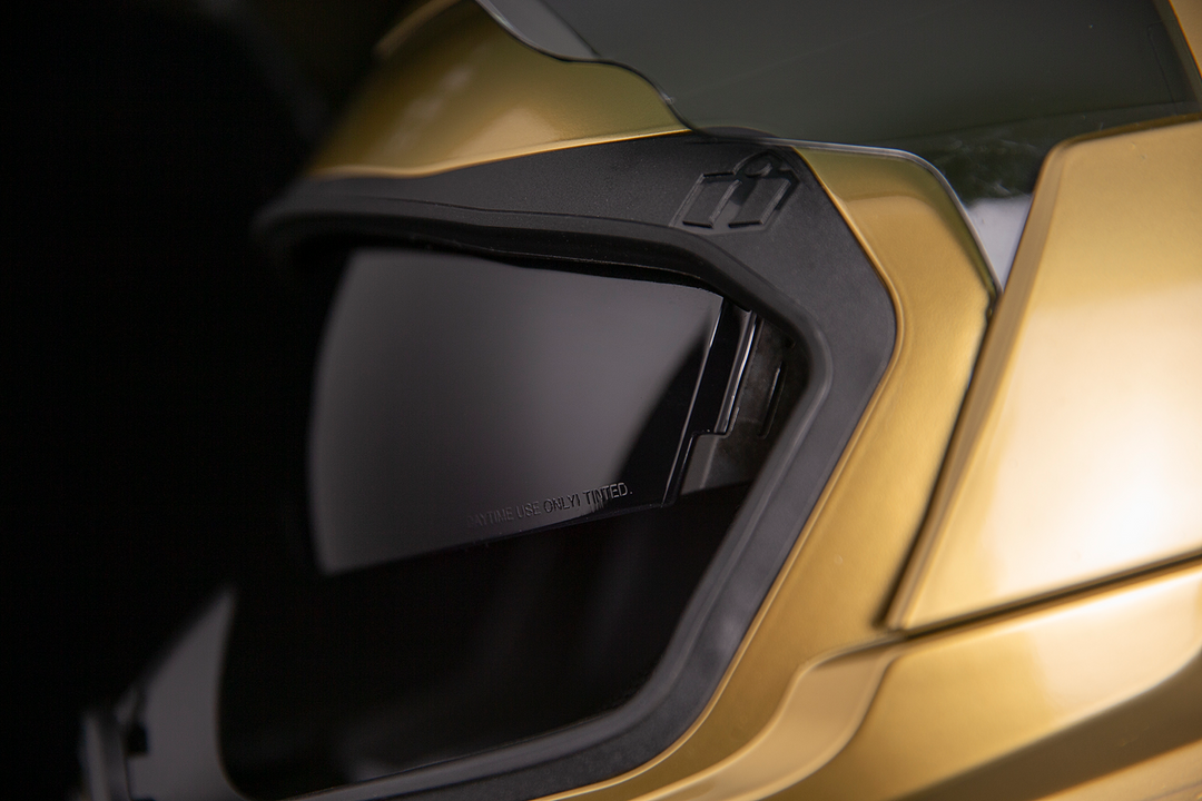 ICON Airflite Jewel MIPS Full Face Motorcycle Helmet Gold - Close-Up of Viewport with Faceshield Raised and Drop Down Sun Visor Lowered