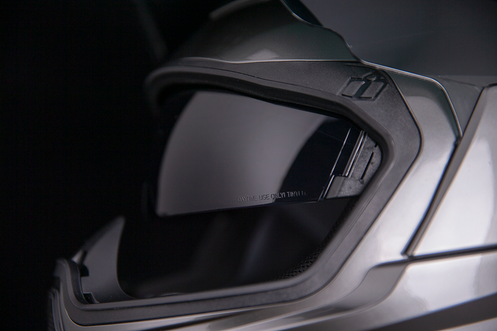 ICON Airflite Jewel MIPS Full Face Motorcycle Helmet Silver - Close-Up of Viewport with Faceshield Raised and Drop Down Sun Visor Lowered