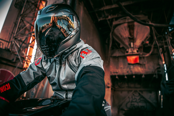 ICON Airflite Jewel MIPS Full Face Motorcycle Helmet Silver - Lifestyle of Rider Wearing Helmet Under Old Bridge