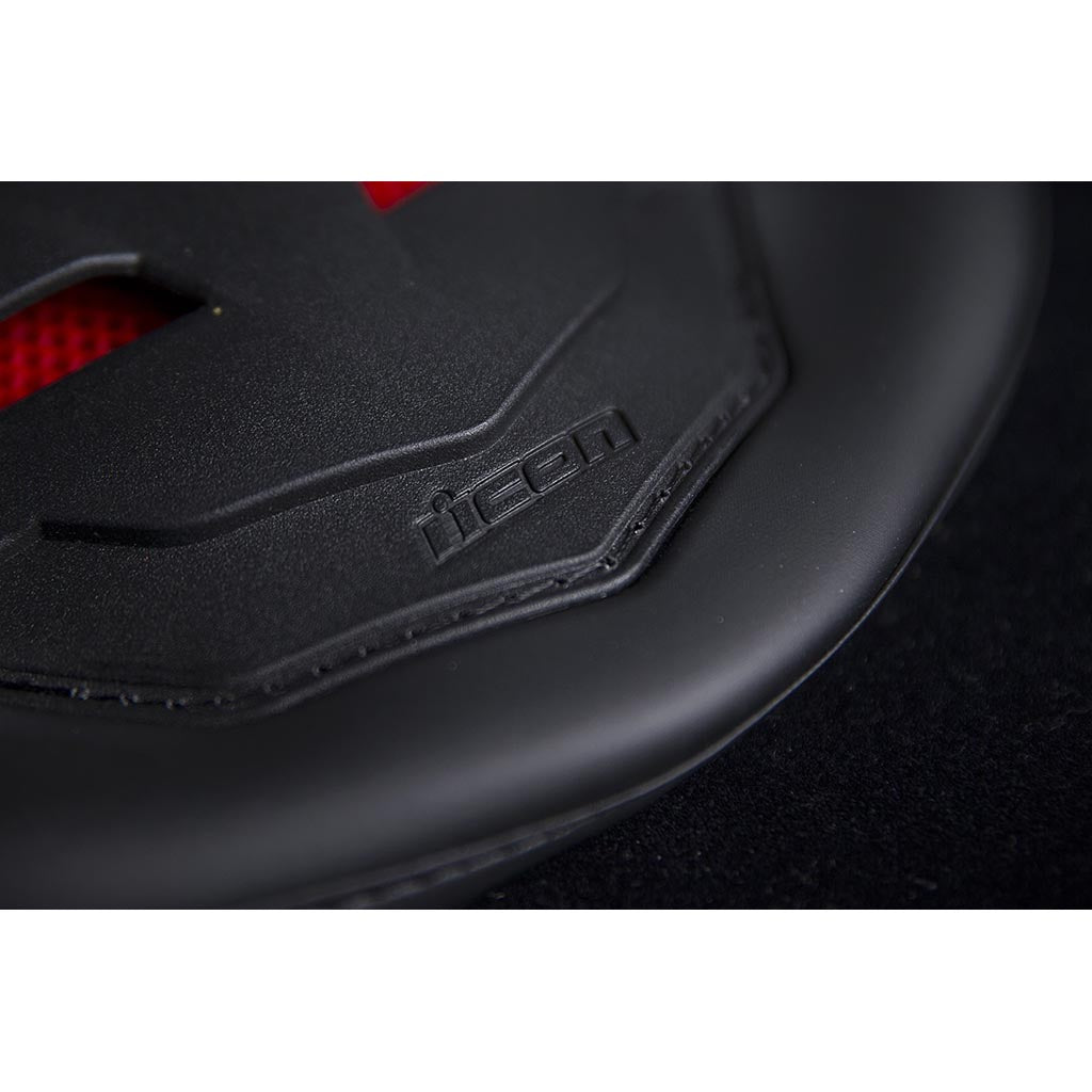 ICON Stryker Vest Red - Close-Up of Logo on Lower Tip of Spine Plate