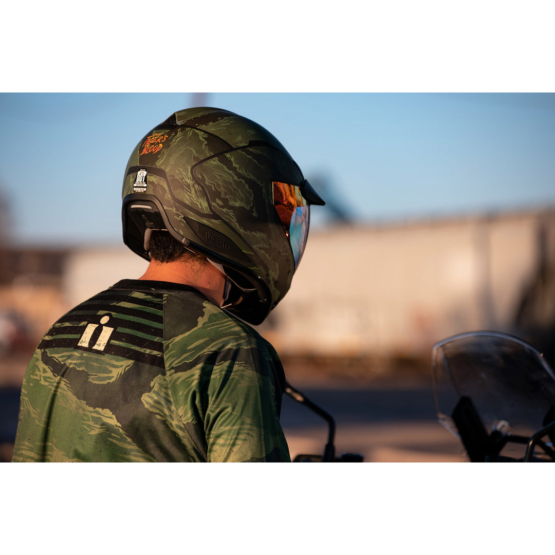 ICON Domain™ Tiger's Blood Helmet Green - Lifestyle Shot from Behind of Rider Wearing Helmet
