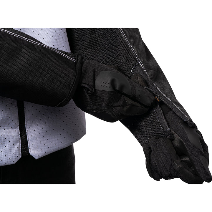 ICON Hooligan™ CE Jacket White - Close-Up of Model Zipping Wrist Zipper
