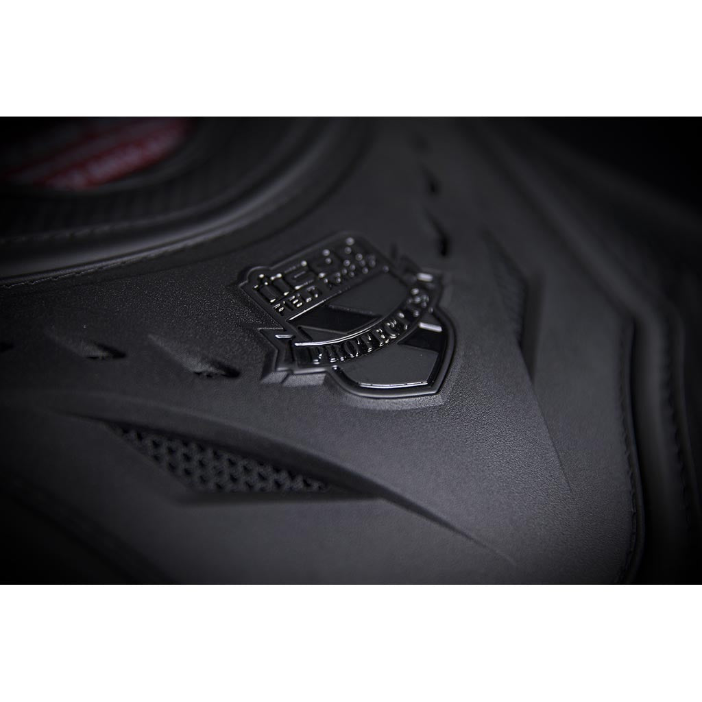 ICON Stryker Vest Stealth - Angled Close-Up of Logo on Chest Plate