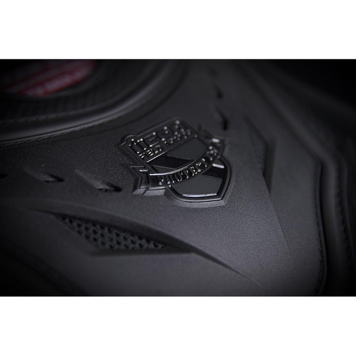 ICON Stryker Vest Stealth - Angled Close-Up of Logo on Chest Plate