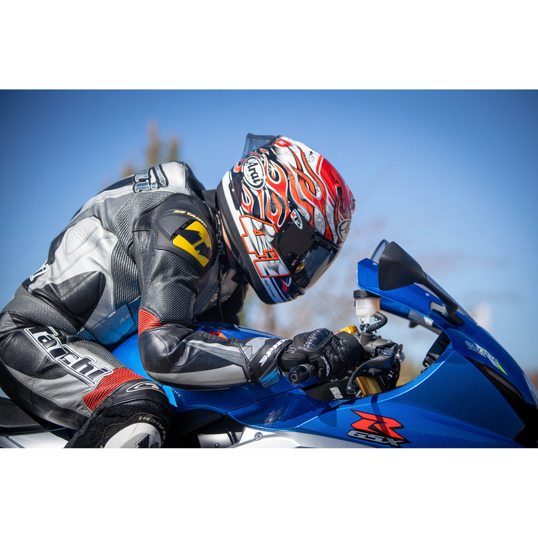 Arai Corsair-X Haga GP Helmet - LIfestyle Shot of racer on blue motorcycle